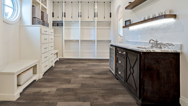 wood-look waterproof luxury vinyl flooring in a laundry room
