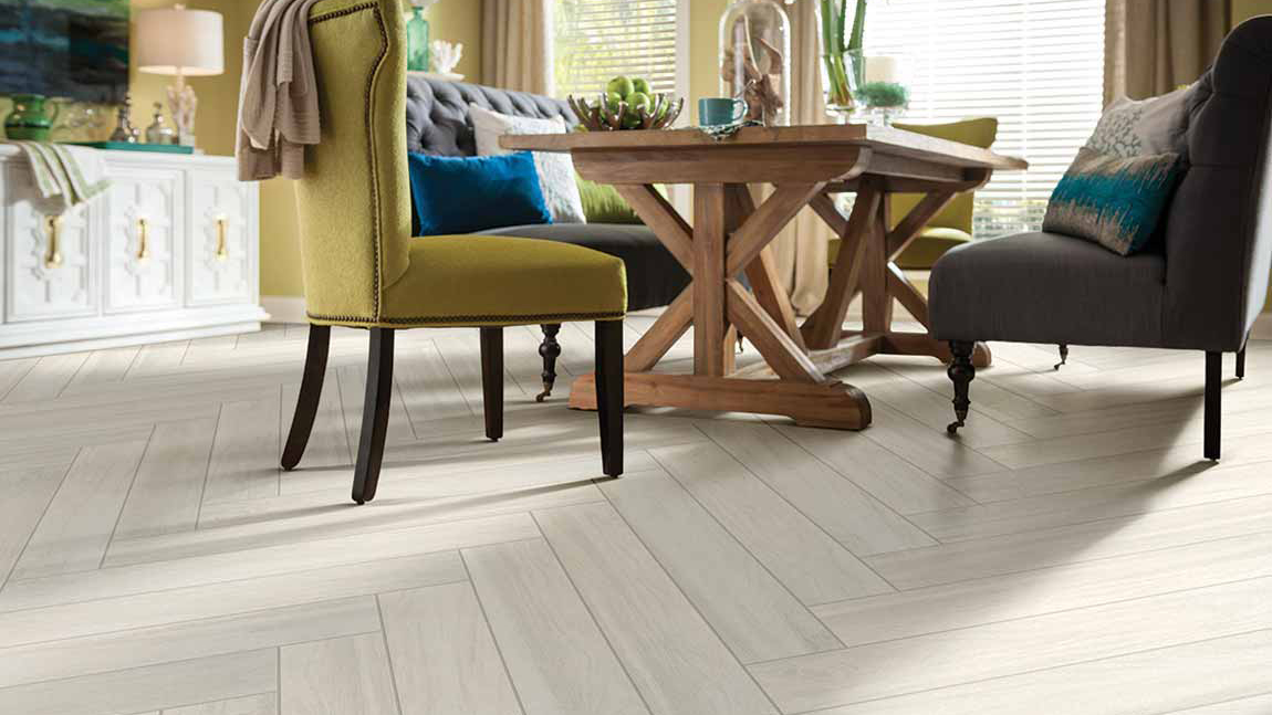 Wood-look tile flooring in a dining room, installation services available.